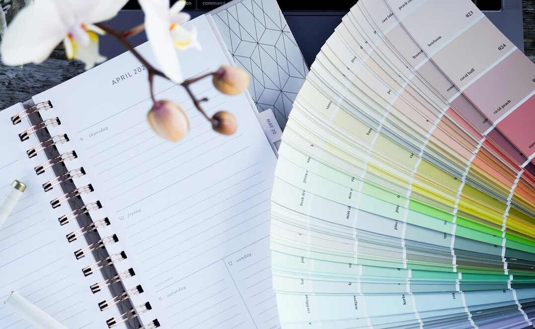 Graphic designer's desk with colour swatches and layout sheets